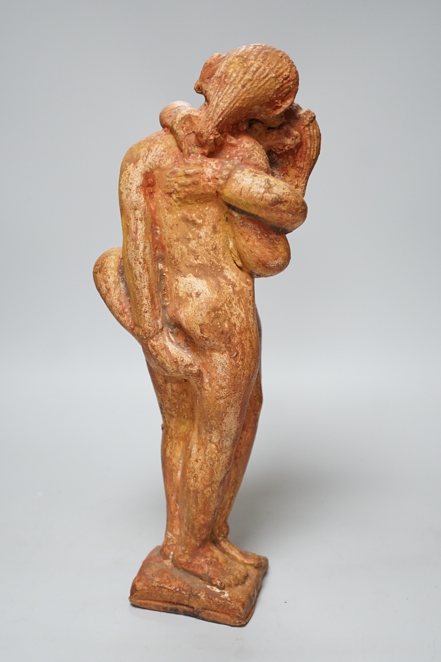 A painted plaster figure of an embracing Indian couple, 37cm tall